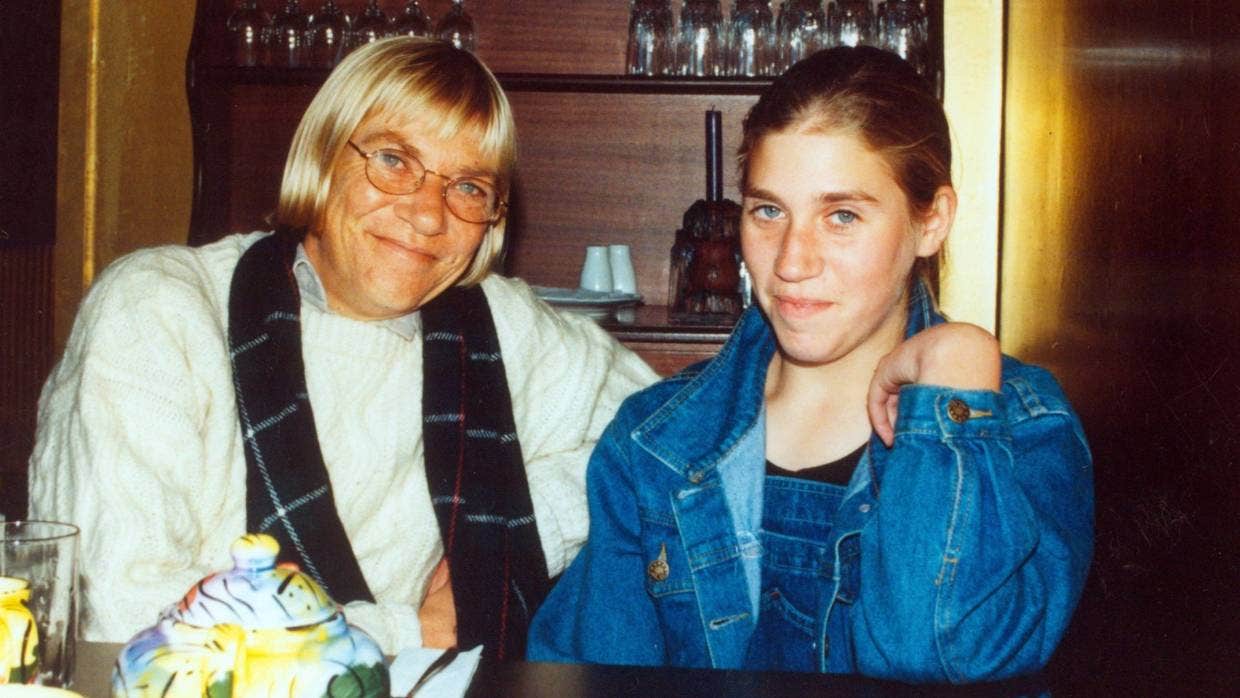 an older woman and younger woman smile into the camera