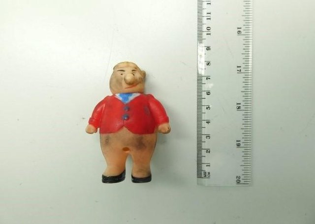 half naked pig type figure in a red coat
