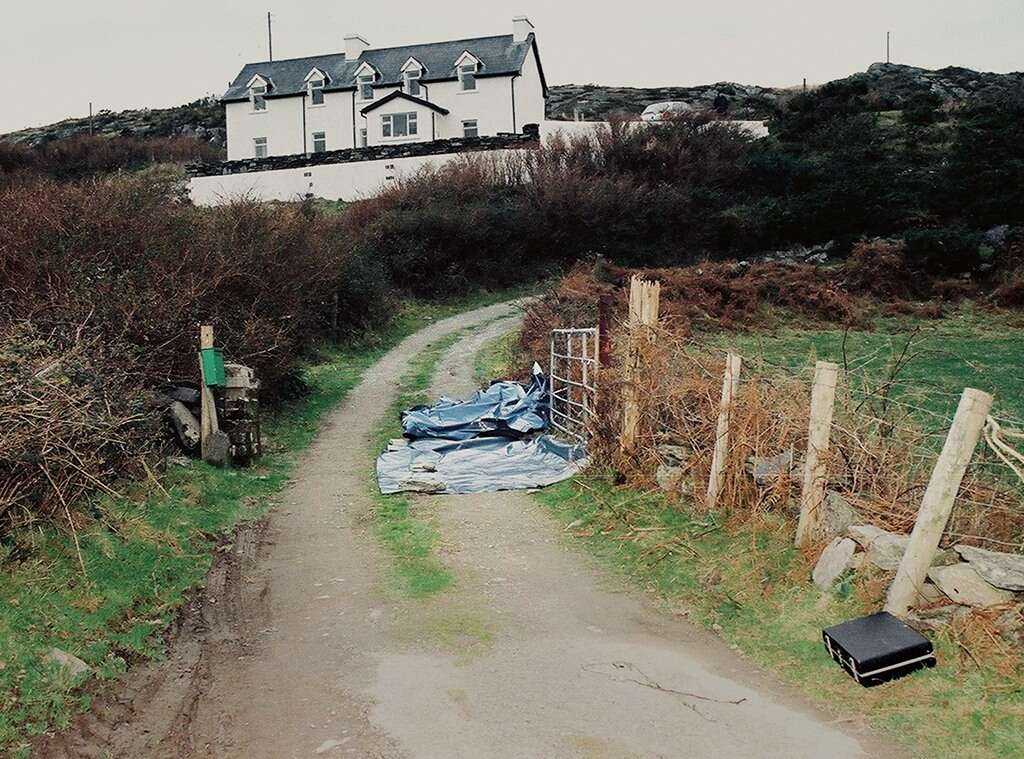 a lane and a gate and a tarpaulin covering a body 
